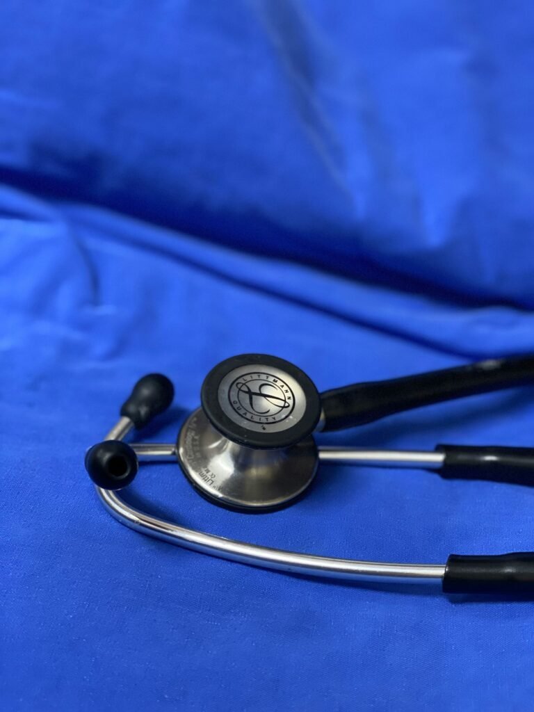 a stethoscope laying on top of a blue sheet